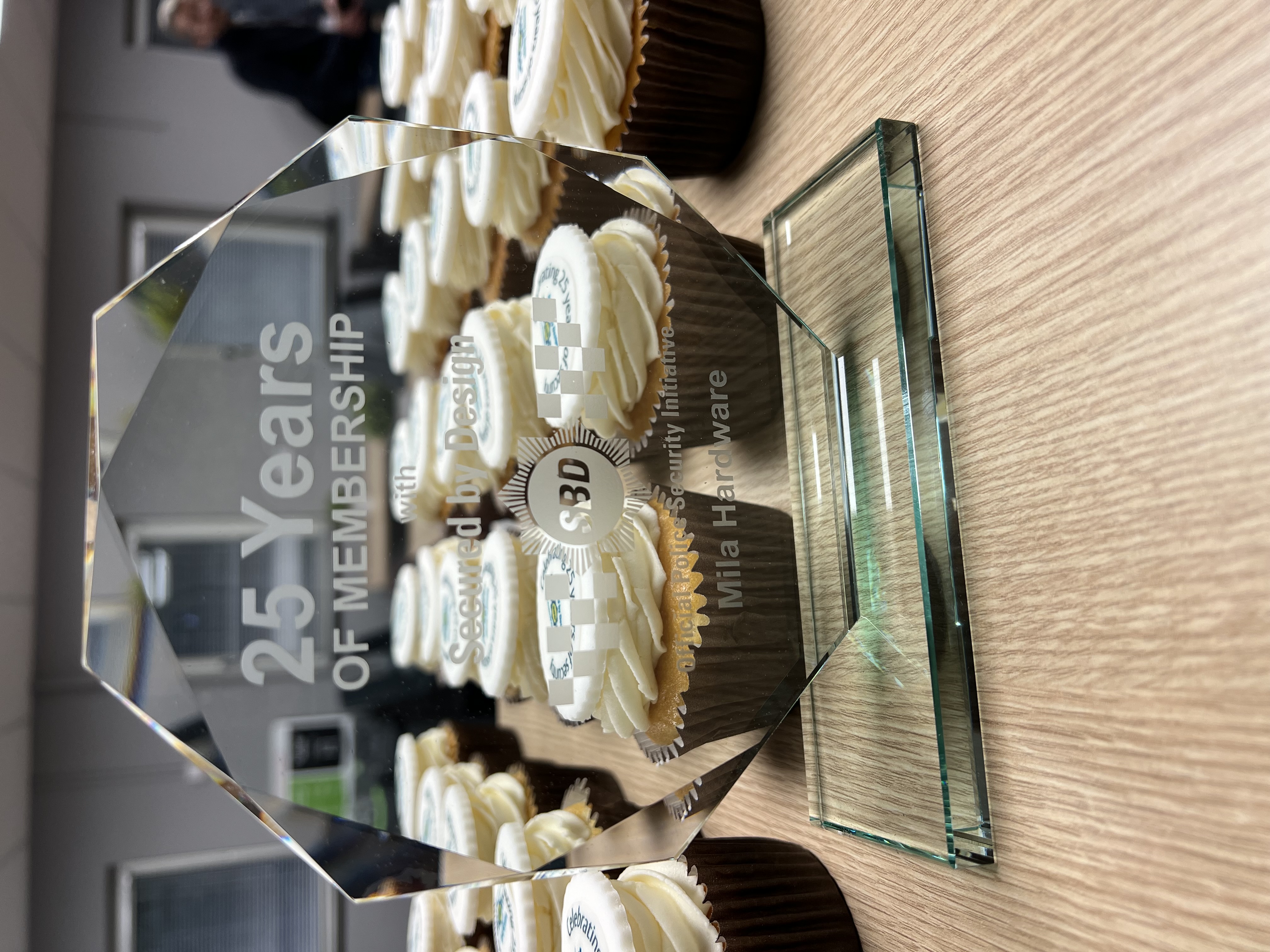 Mila and SBD Celebrate 25-Year Partnership with Award and Cake!